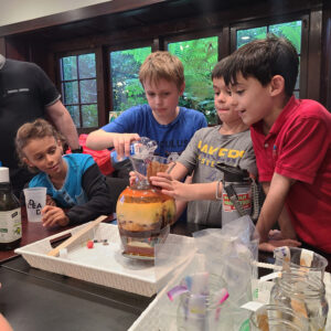 4 Academy students participating in a density experiment at the Institute for Educational Advancement