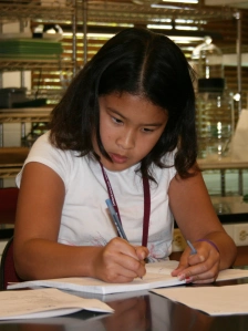 girl writing with concentration